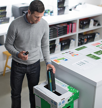 Man puts cartridge in recycling bin