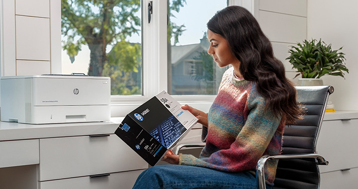 Woman holds a HP toner package