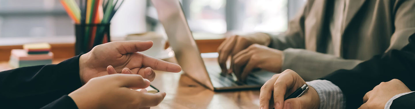 Business people sitting in a meeting room with a contract