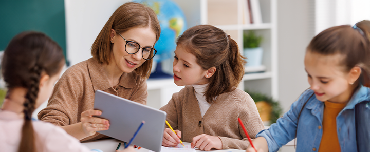 A teacher explains a subject on a tablet
