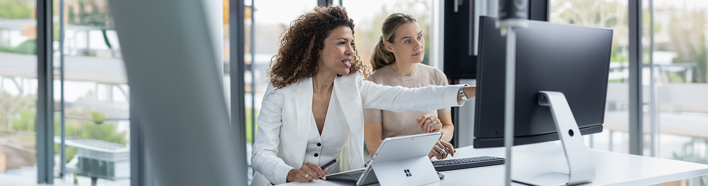 Two women are working at a computer