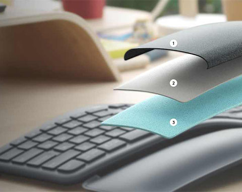 Three ergonomic wrist rests in different colors designed to support during computer work