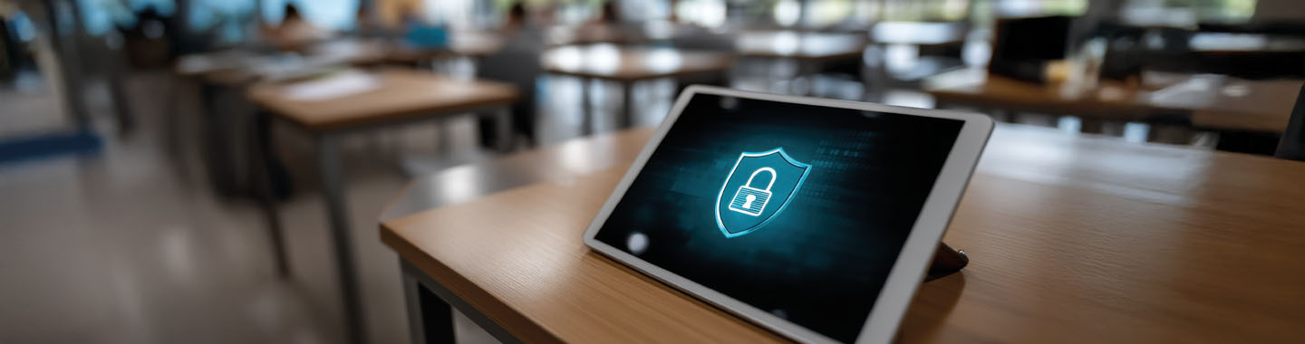 Tablet on a school desk with security icon on screen